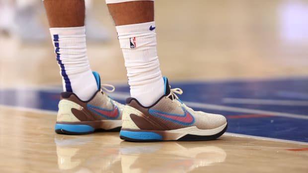 View of pink and blue Nike Kobe shoes.